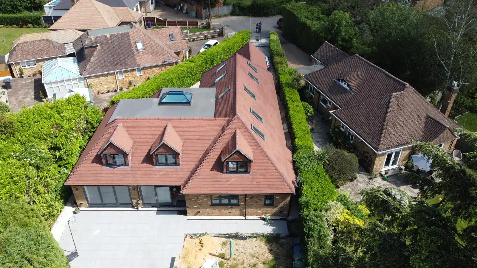Aerial view of a house with a newly tiled roof, by Dchampion Roofing