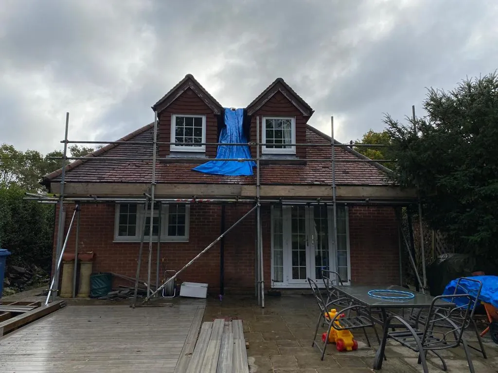 Scaffold sheeting stretched across a lift of scaffolding to keep weather off the elevation behind it